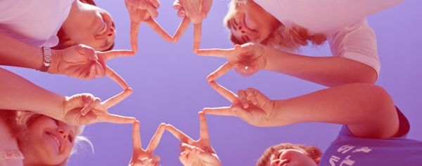 Schüler bilden mit ihren Fingern einen Stern